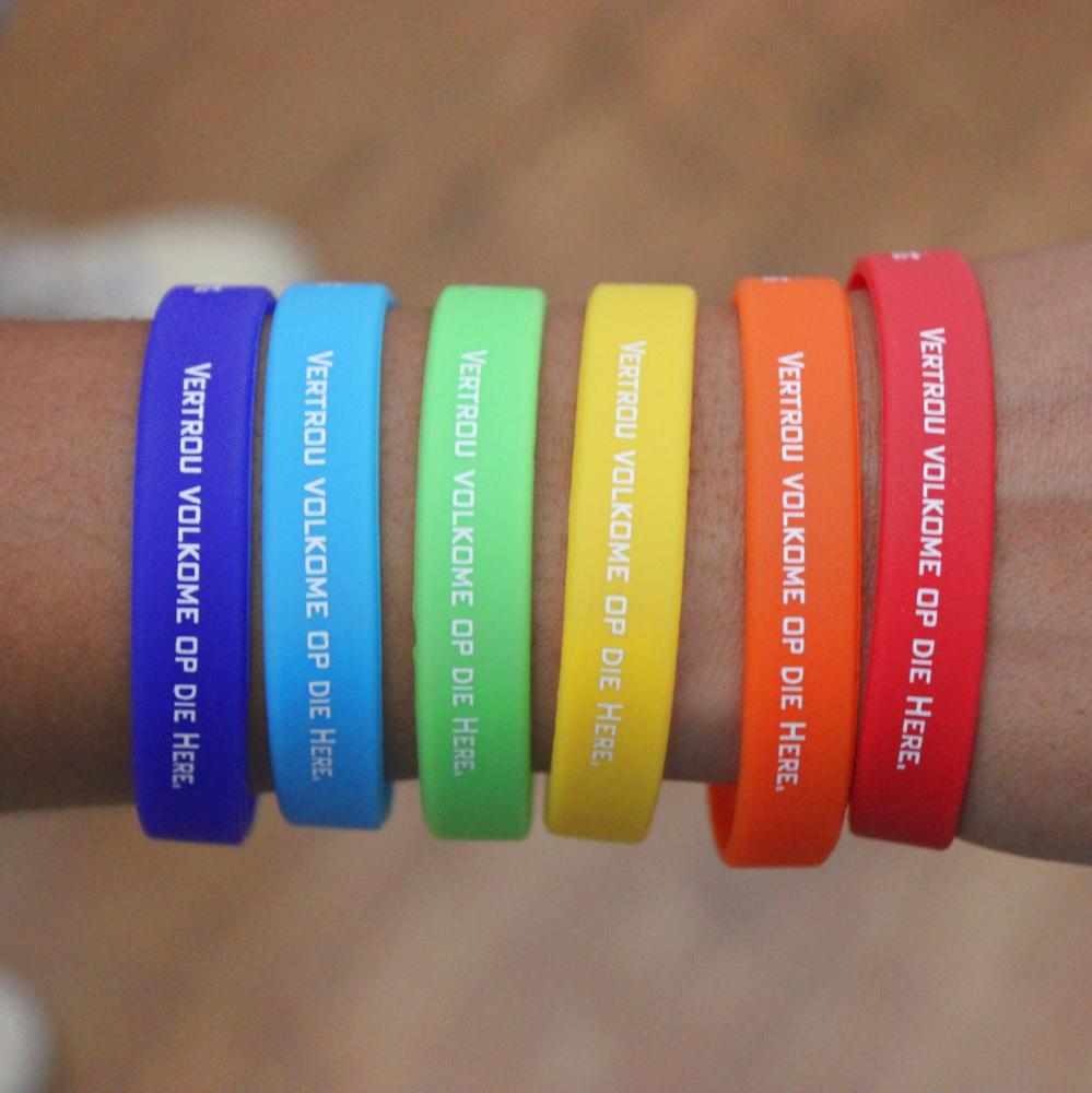 Colourful Christian Silicone Wristbands on a lady's arm