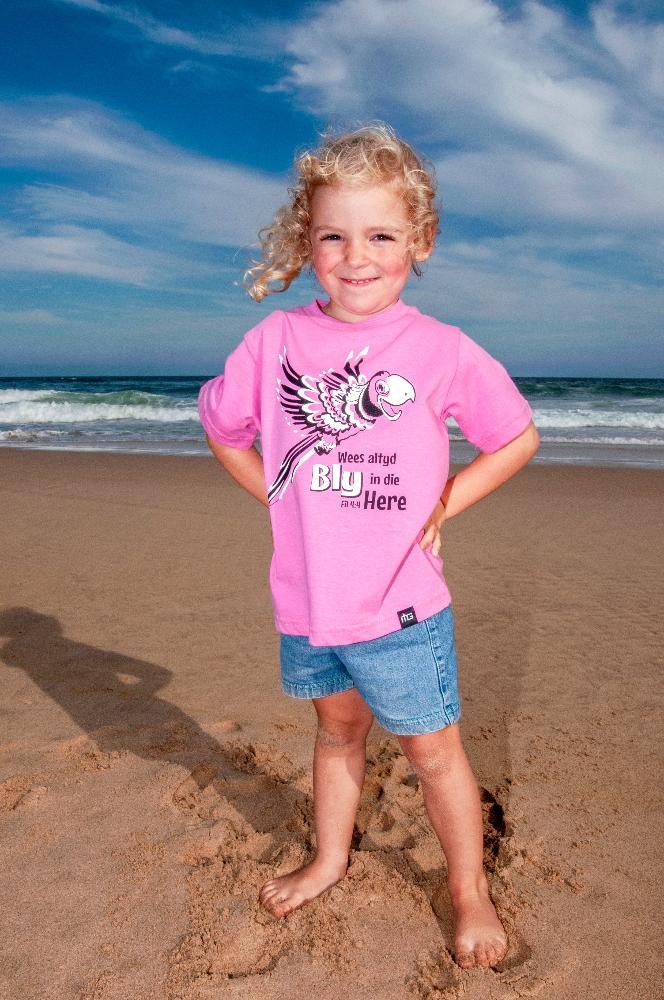 A little girl wearing a Pink "Wees Bly in die Here" Christian Kids T shirt for girls- ITG Clothing South Africa